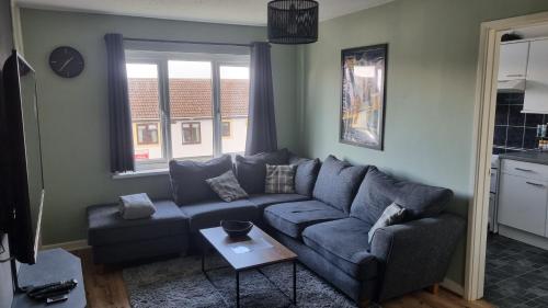 a living room with a couch and a table at 2 Bedroom 1st floor flat Brean in Brean