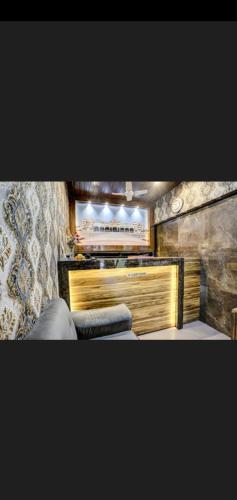 a living room with a couch and a mirror at Hotel Green Park in Mumbai