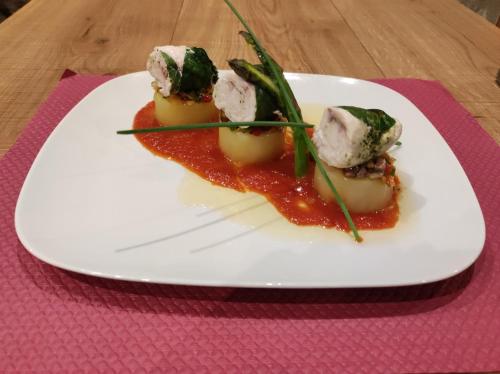 a white plate with some food on a table at Auberge du Bon Vivant in Argelès-sur-Mer