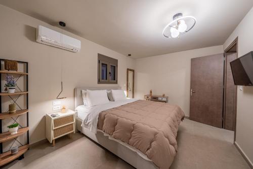 a bedroom with a large bed and a television at Ariadne's House in Sami