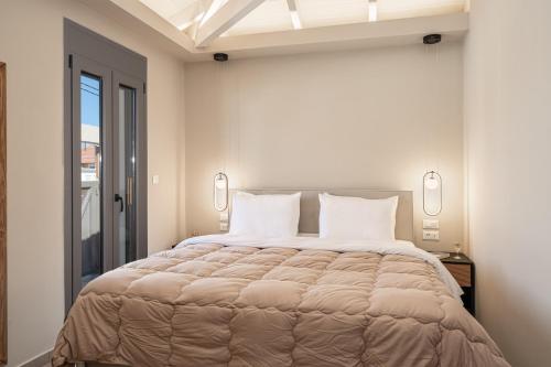 a bedroom with a large bed with white pillows at Ariadne's House in Sami