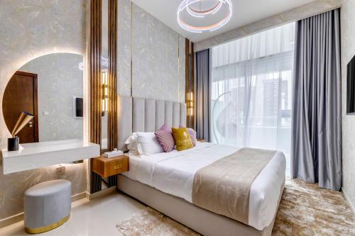 a bedroom with a large bed and a large window at GlobalStay Reva & Vera Residences Business Bay Apartments in Dubai