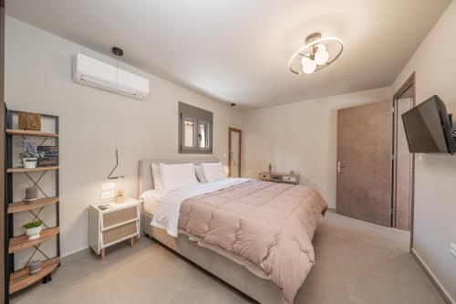a bedroom with a large bed and a television at Ariadne's House in Sami