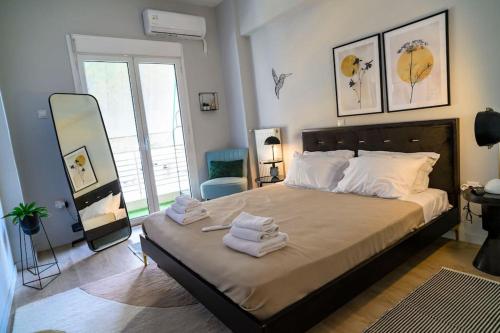 a bedroom with a large bed with towels on it at Cosy Contemporary Luxury Urban Retreat in Athens in Athens