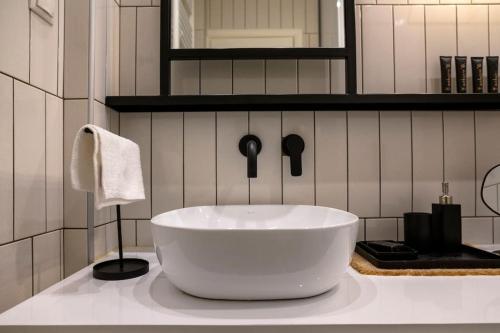 a bathroom with a large white bowl sink on a counter at Cosy Contemporary Luxury Urban Retreat in Athens in Athens