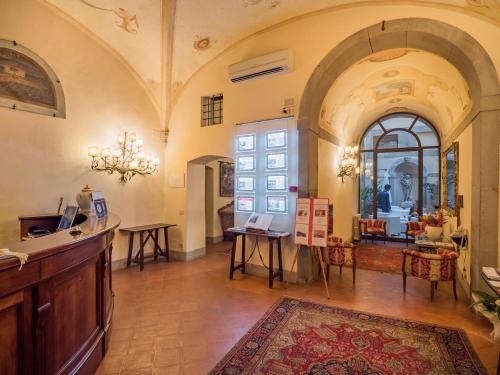 a large room with a counter and a table and chairs at B&B Piccolo Hotel in Cortona