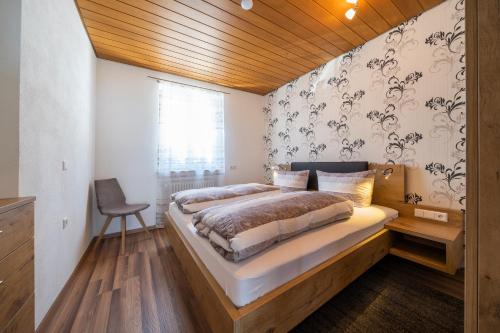 a bedroom with a large bed with a wooden ceiling at Gästehaus am Bodensee in Immenstaad am Bodensee