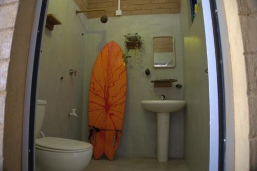 a bathroom with two surfboards on the wall at PASSIONFRUIT HOMESTAY in Matara