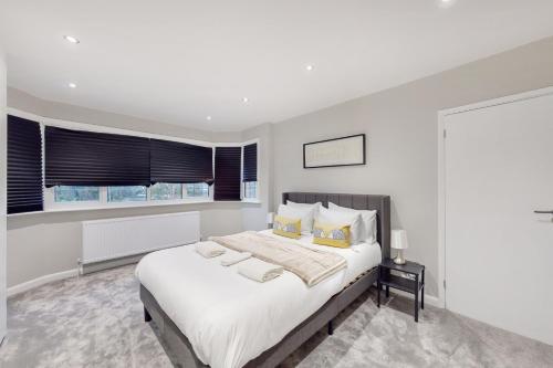 a white bedroom with a large bed and a window at Brand New 3BDR with Garden&Free Parking in Hendon in Hendon