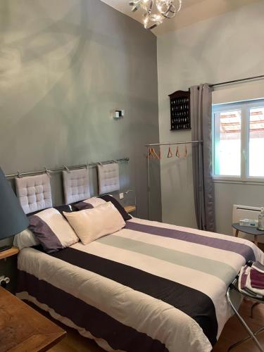 - une chambre dotée d'un grand lit avec des oreillers violets et blancs dans l'établissement La Guette, à Cercy-la-Tour