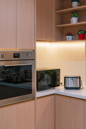 a kitchen with a stove and a toaster oven at MODERN - CITY CENTER, Phrom Phong BTS, Em District, Terminal 21, MAX 14 People in Bangkok