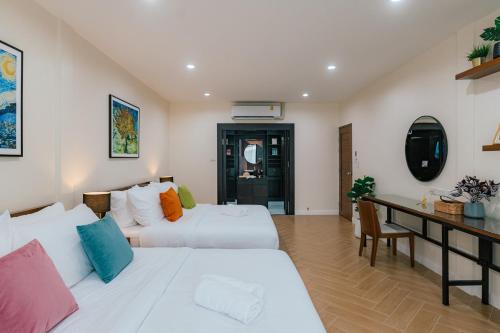 a hotel room with two beds and a desk at MODERN - CITY CENTER, Phrom Phong BTS, Em District, Terminal 21, MAX 14 People in Bangkok