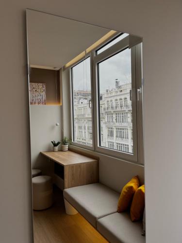 a room with a window with a bench and a table at Pelagus City - Luxury Suite II in Thessaloniki