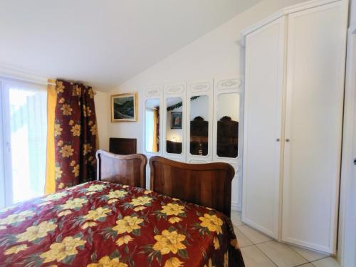 a bedroom with a bed with a floral bedspread at Mansarda di Masha in Villongo SantʼAlessandro