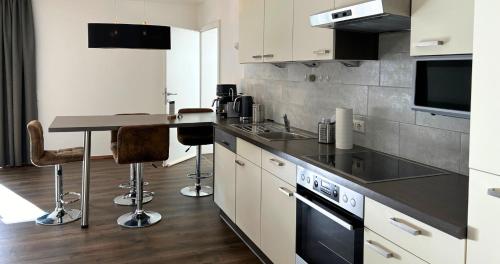 a kitchen with a counter and a table in it at streitbergers. Appartement in Maishofen