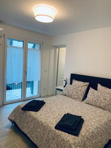 a bedroom with a bed with two towels on it at Piccola Corte in Udine