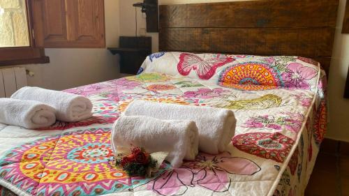 a bedroom with two beds with towels on them at Alojamientos La Dehesa in El Berrueco