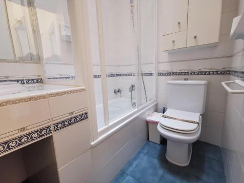 a white bathroom with a toilet and a sink at Casa Sant Feliu de Guíxols, 3 dormitorios, 6 personas - ES-209-18 in Sant Feliu de Guíxols