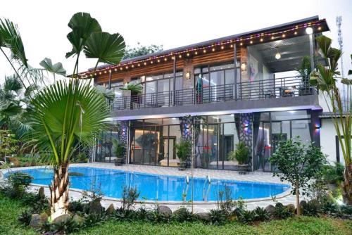 a house with a swimming pool in front of it at Phúc Hưng Kazin Homestay Ba vì in Ba Vì