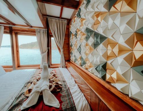 a bed in a boat with a view of the water at Dav-Venture in Labuan Bajo