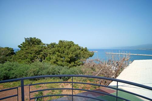 a balcony with a view of a body of water at Karnagio Rooms in Kyparissia