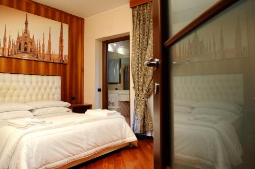 a bedroom with two beds and a door open at Hotel Malpensafiera in Bernate Ticino