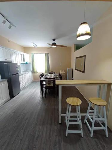 a room with a kitchen and a table and chairs at Urban Zen in Calamba