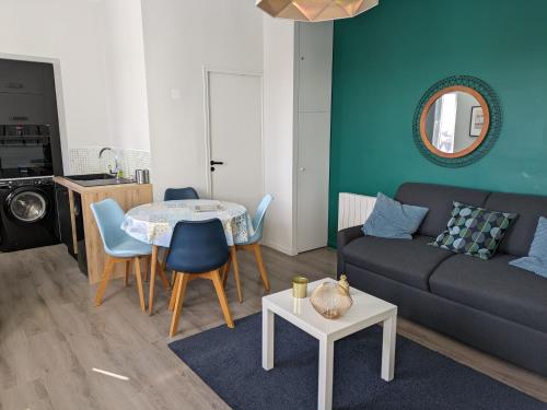 un salon avec un canapé et une table dans l'établissement Appartement lumineux centre digue, à Wimereux