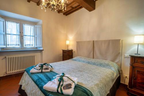 a bedroom with a bed with two towels on it at La Dimora nell'Anfiteatro Superior room and apartment Self check in Elevator Air Conditioning in Lucca
