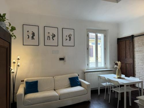 a living room with a couch and a table at Maison Leone Apartment in Ravenna