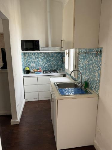 a small kitchen with a sink and a stove at Maison Leone Apartment in Ravenna