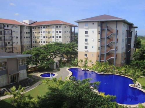 an aerial view of an apartment complex with a swimming pool at Serenity in Style: Scandinavian Zen in Nuvali in Pitland
