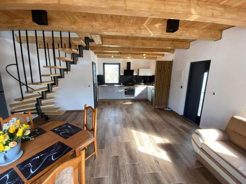 a living room with a spiral staircase in a house at Rodzinna Przystań in Lubawka