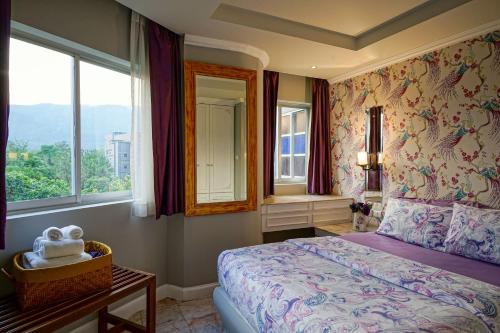 a bedroom with a bed and a window at At Pingnakorn Nimman Hotel in Chiang Mai