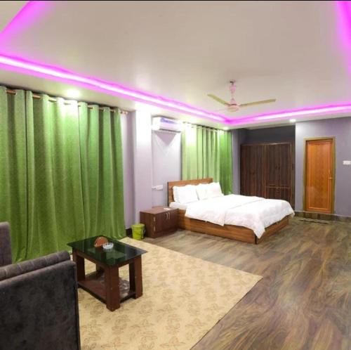 a bedroom with a bed and a green curtain at Cozy Nest Homestay in Guwahati