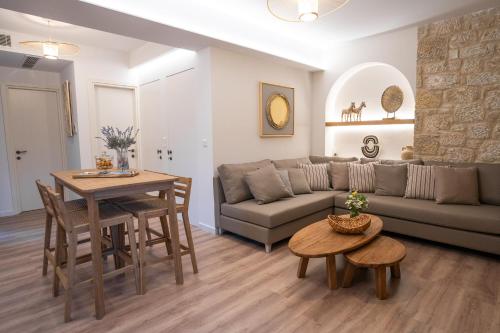 a living room with a couch and a table at Olvio Suites in Kardamili