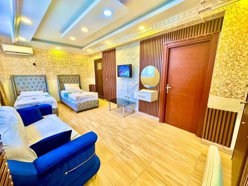 a hotel room with two beds and a blue couch at Sultanahmet life suites apartment in Istanbul
