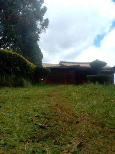 a yard with a building and a field of grass at JA STEP in Nairobi