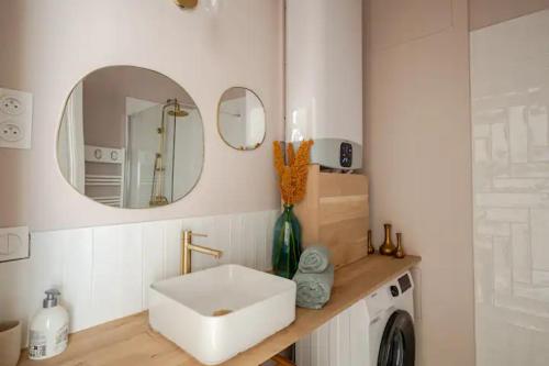 a bathroom with a sink and a mirror at "La Baigneuse" Vallon des Auffes in Marseille
