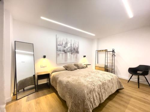 a bedroom with a bed and a mirror and a chair at Lemon & Muralla -Céntrico-Nuevo-Premium in Murcia
