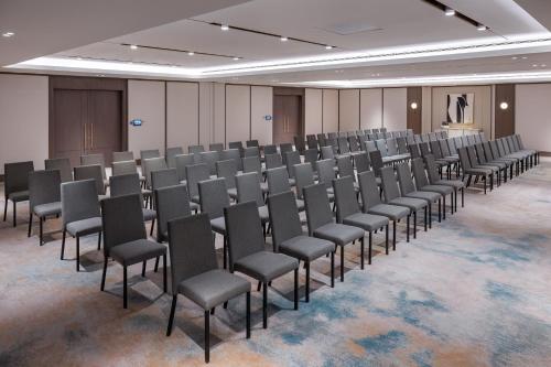 a room with rows of chairs and a podium at Address Beach Resort Bahrain in Manama