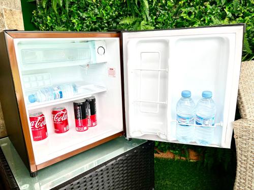an open refrigerator with bottles of water in it at Lucus Skyline & Terrace by Lugo Collection in Lugo