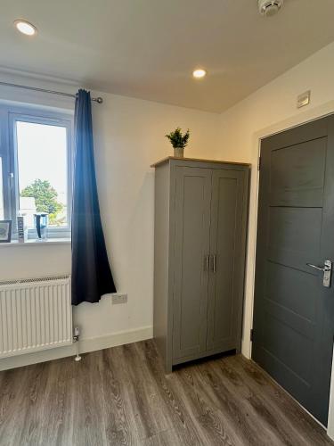 an empty room with a door and a window at Wonderful Double Room In House in London