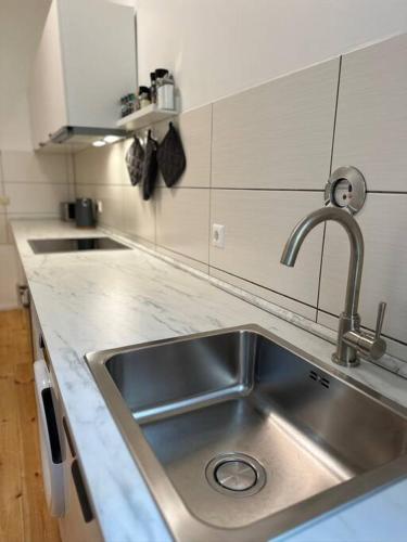 a kitchen with a sink and a counter top at Modern 2Room Apartment/Neukölln in Berlin