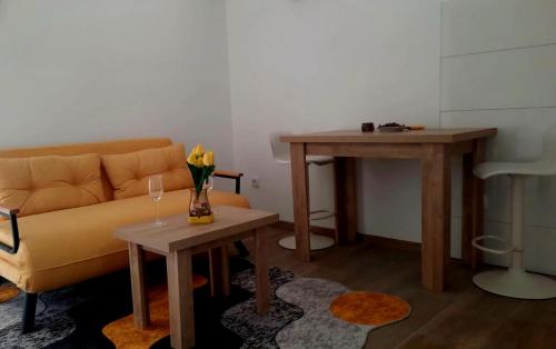 a living room with a couch and a table at Slatkiš Sweet in Banja Koviljača