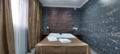 a room with two beds with towels on a table at EVFRAT-Q in Taraz