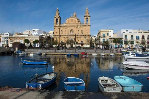 a group of boats in a harbor with a building at Modern 3BR home with Stunning Marina View in Pieta by 360 Estates in Tal-Pietà