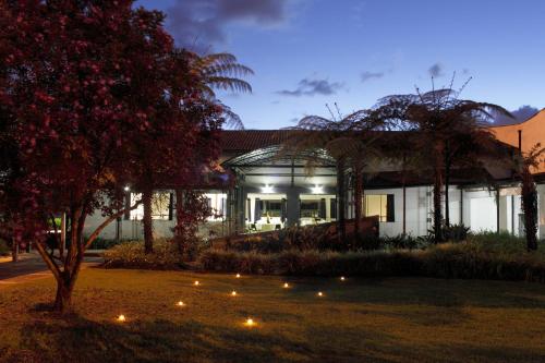 a house at night with lights in the yard at Estelar Recinto Del Pensamiento Hotel Y Centro De Convenciones in Manizales