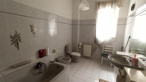 a bathroom with a tub and a toilet and a sink at Don Aurelio in città - 2 in Acireale