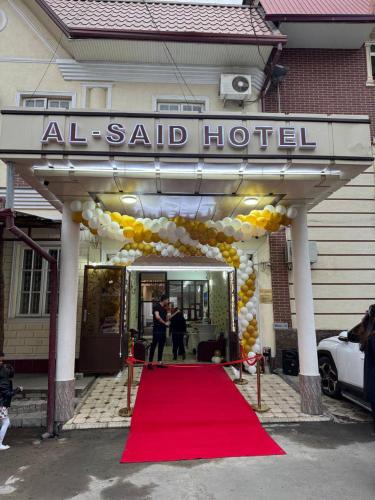 タシュケントにあるAL-SAID Hotelの赤いカーペットと風船を使用したホテルの前の赤いカーペット